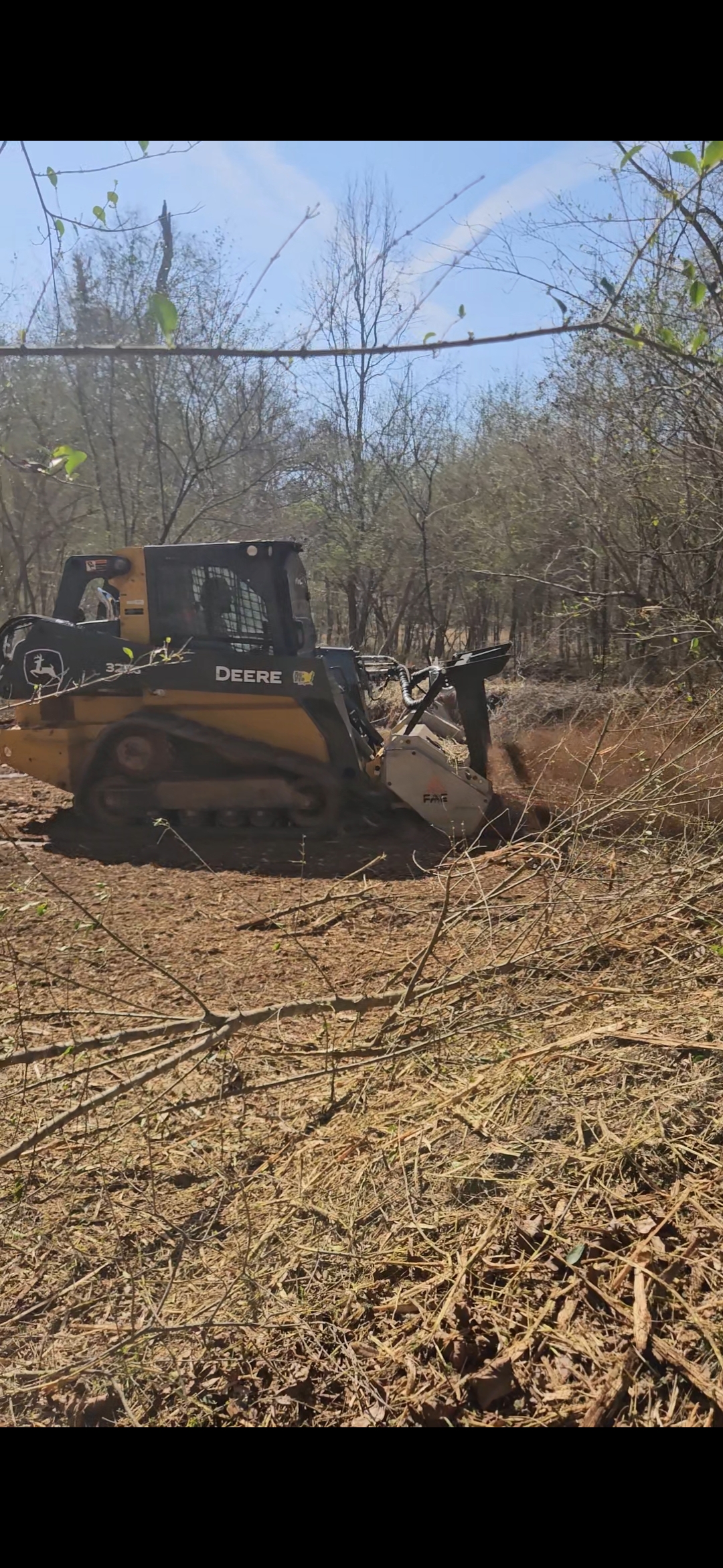 Fisher's Forestry John Deere skid steer forestry mulcher grinding brush on half acre job in Travelers Rest SC